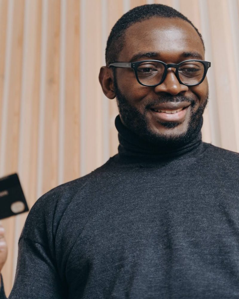 cheerful-african-american-businessman-holding-credit-card-and-smartphone-for-shopping-in-internet-1.jpg